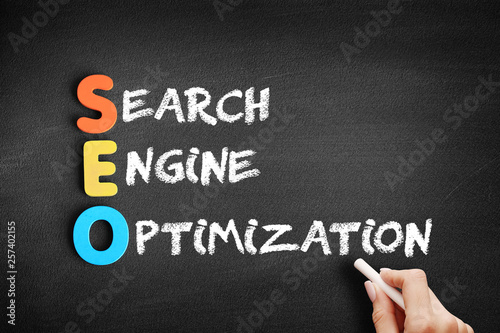 Color Wooden alphabets building the word SEO - Search Engine Optimization acronym on blackboard
