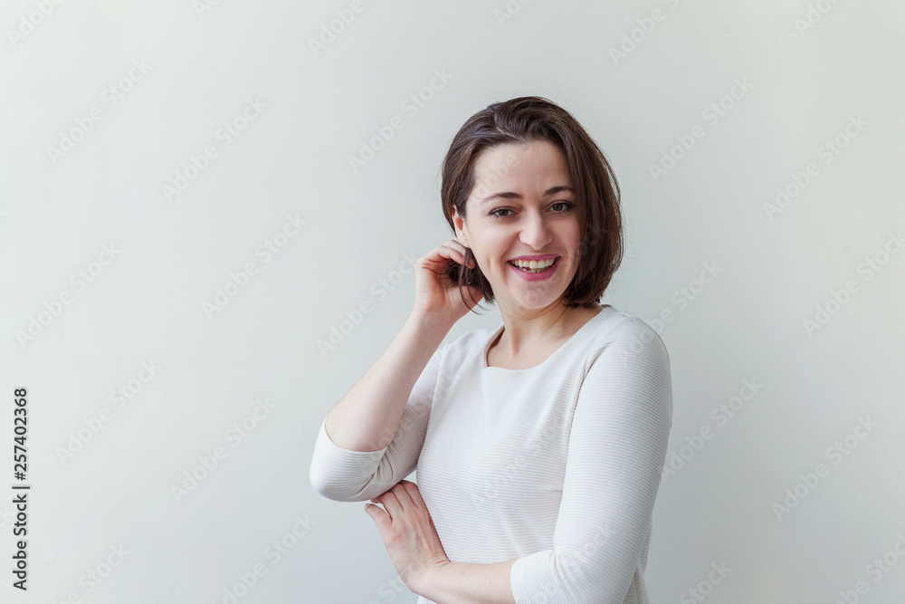 Happy girl smiling. Beauty portrait young happy positive laughing brunette woman on white background isolated. European woman. Positive human emotion facial expression body language Happy girl smiling. Beauty portrait young happy positive laughing brunette woman on white background isolated. European woman. Positive human emotion facial expression body language