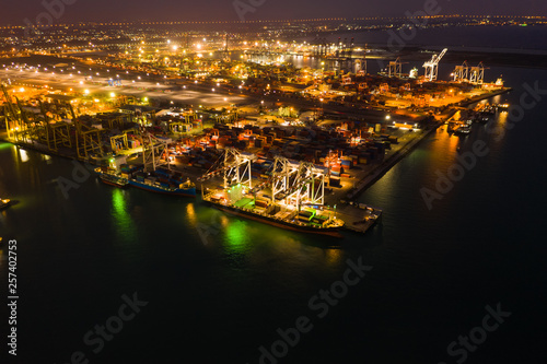 cargo loading station for international export and import by ship with containers open sea at night