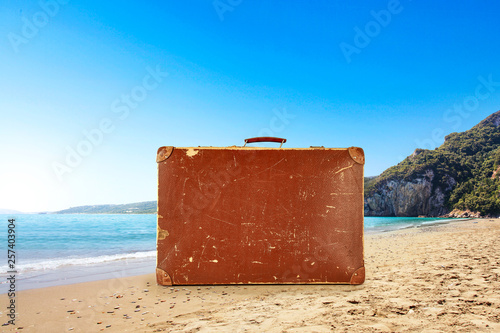 Summer brown suitcase on beach and free space for your decoration.  © magdal3na