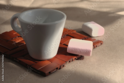 A cup of morning aromatic invigorating coffee on a wicker wooden stand.