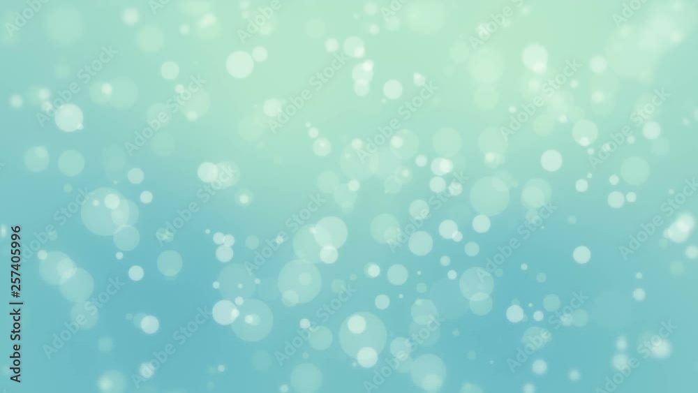 Glowing blue green bokeh background with floating light particles. Glowing blue green bokeh background with floating light particles.