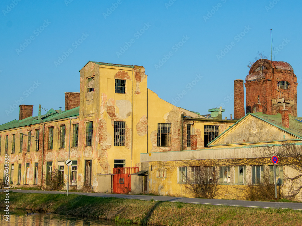Abandoned factory next to a canal in evening light
