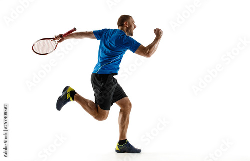 Fototapeta Naklejka Na Ścianę i Meble -  Portrait of a handsome male tennis player celebrating his success isolated on a white studio background. Human emotions, winner, sport, victory concept