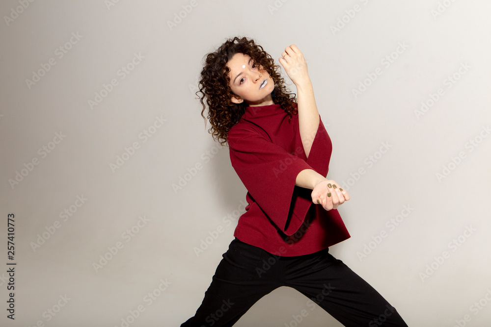People, youth, leisure and lifestyle concept. Fashionable Caucasian young female student wearing stylish red clothing laughing happily, having fun in photo studio. Copy Space People, youth, leisure and lifestyle concept. Fashionable Caucasian young female student wearing stylish red clothing laughing happily, having fun in photo studio. Copy Space