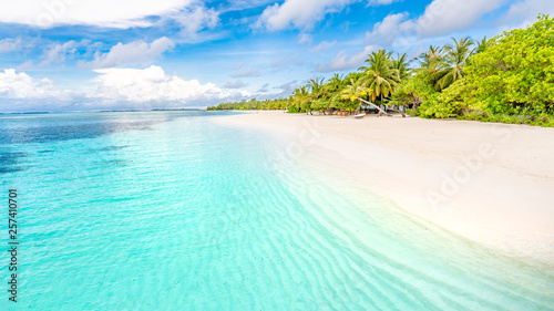 Beautiful Maldives island beach landscape. Luxury resort with chairs and umbrella for summer vacation and holiday background. Exotic tropical beach concept