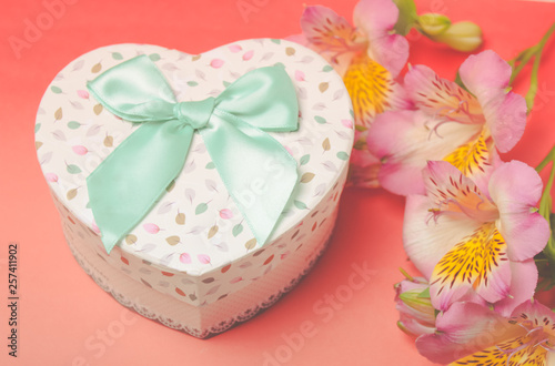  gift box with alstroemeria flowers on pastel background. Spring composition. Springtime. Mother`s day card