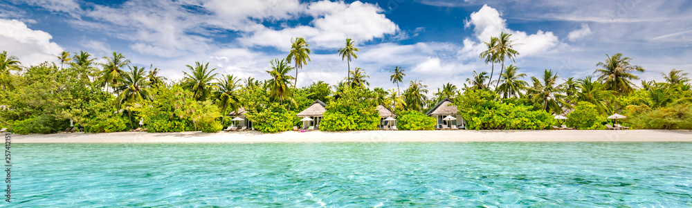 Panoramic beach landscape. Maldives island wonderful scenery, luxury beach villas and palm trees over white sand. Exotic vacation and beach holiday template banner