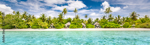 Panoramic beach landscape. Maldives island wonderful scenery, luxury beach villas and palm trees over white sand. Exotic vacation and beach holiday template banner