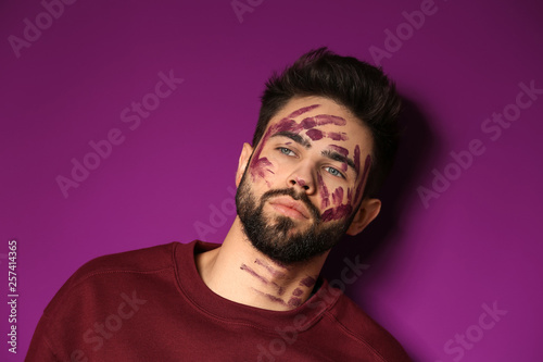Portrait of handsome man with paint on his face against color background © Pixel-Shot