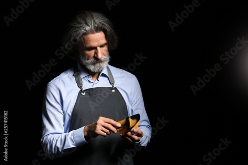Male owner of cheese store ...