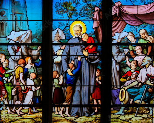 Saint Vincent de Paul on a Stained Glass in Paris photo