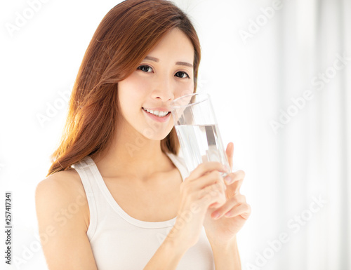 smiling beautiful young woman drinking water