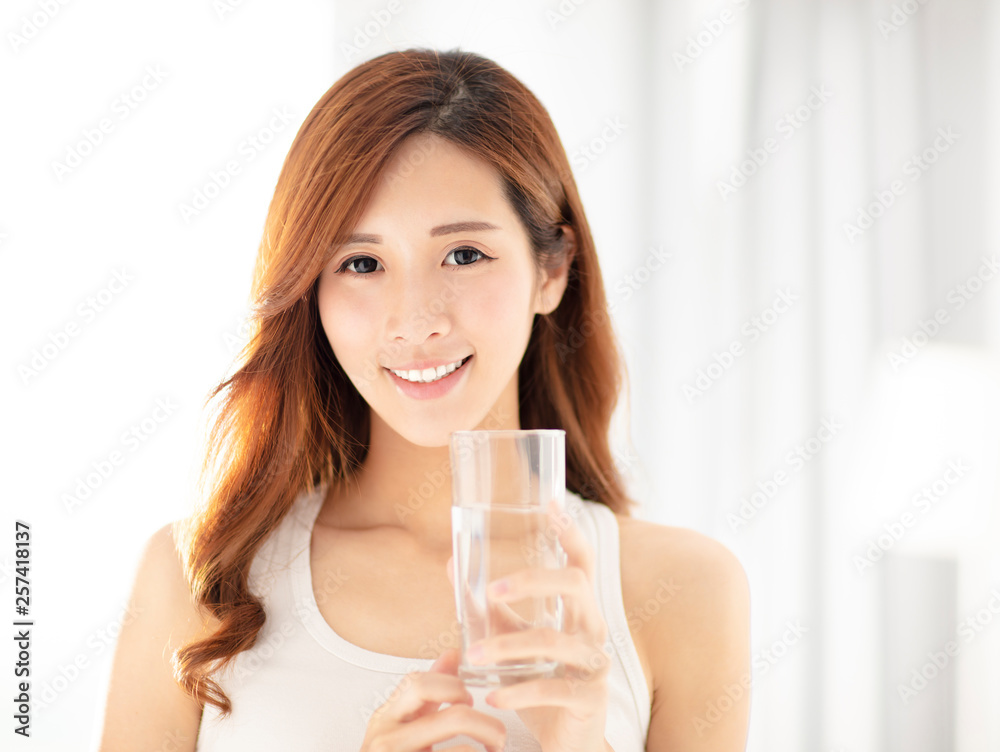 smiling beautiful young woman drinking water smiling beautiful young woman drinking water