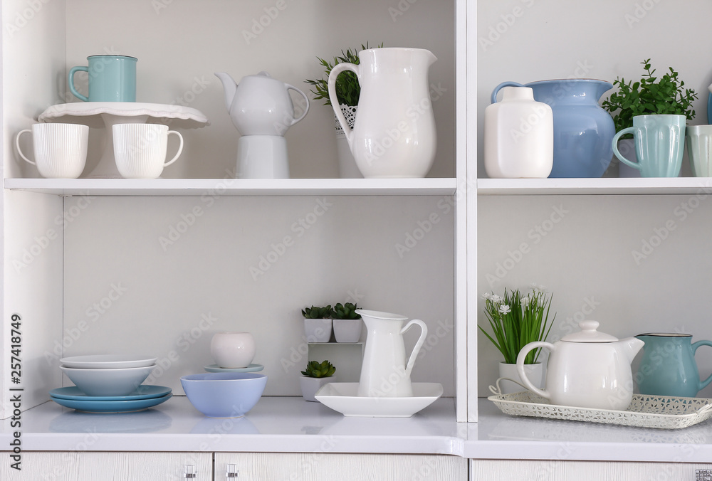 Open cupboard with clean dishes in kitchen Open cupboard with clean dishes in kitchen