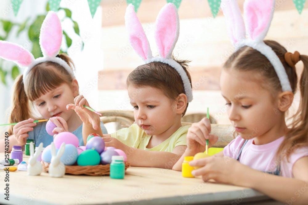 Cute children painting Easter eggs at home Cute children painting Easter eggs at home