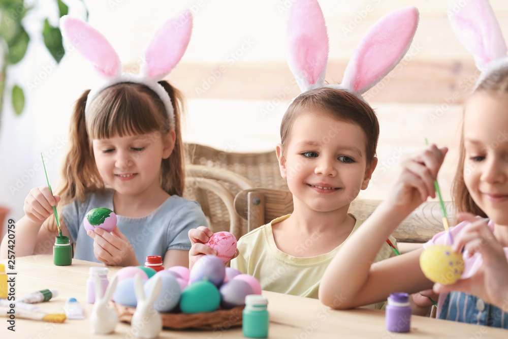 Cute children painting Easter eggs at home Cute children painting Easter eggs at home