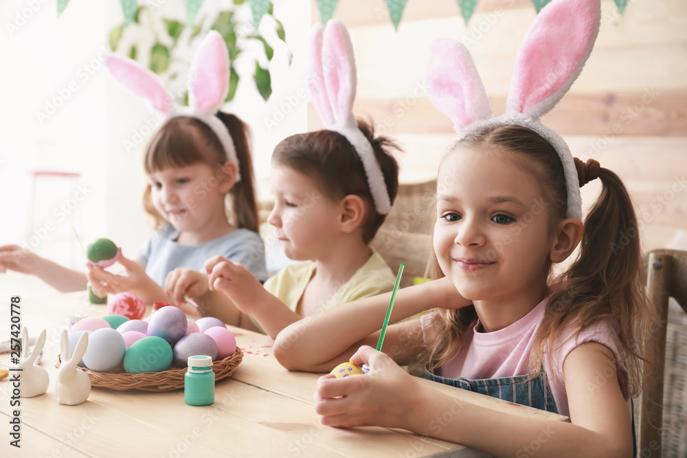 Cute children painting Easter eggs at home Cute children painting Easter eggs at home