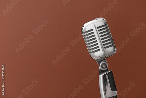 Retro microphone on color background