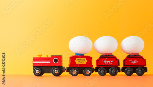 Easter egg on wooden toy train with copy space for texts.Vintage color toned for Easter concept background.