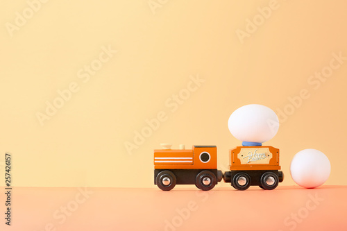 Easter egg on wooden toy train with copy space for texts.Vintage color toned for Easter concept background.