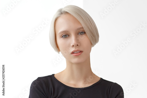Bilde på lerret Portrait of young girl with blond short hairstyle looking at camera