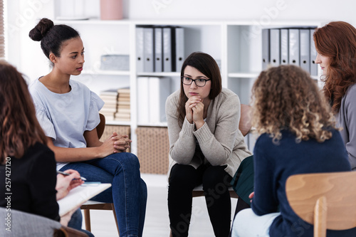 Thoughtful woman at issues support group meeting for women