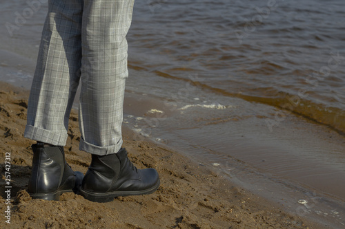 Boots stand on the shore