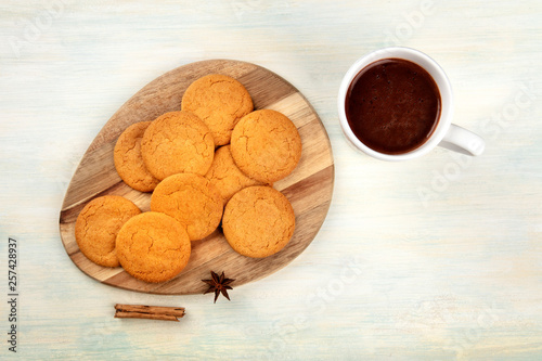 Ginger cookies, shot from the top with a cup of hot chocolate and spices, anise and cinnamon, and a place for text