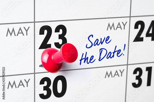 Wall calendar with a red pin - May 23 photo