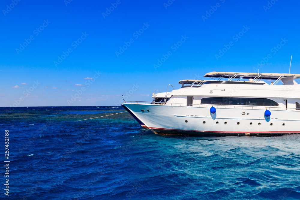 White yacht anchored near coral reef in Red sea, Egypt