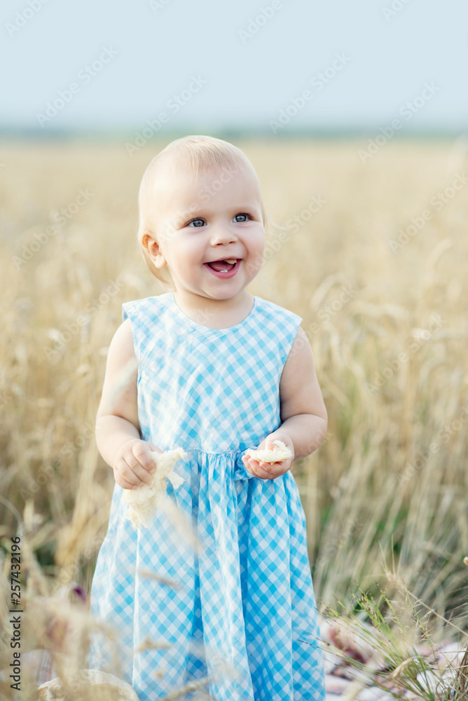 cute happy little girl in wheat field on a warm summer day cute happy little girl in wheat field on a warm summer day