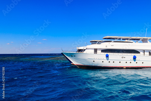 White yacht anchored near coral reef in Red sea, Egypt