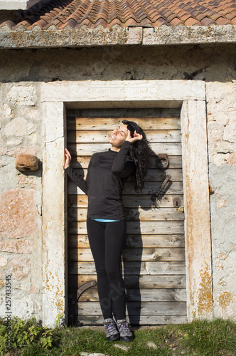 break during the mountain ascent / happy girl near the old mountain stall door during a mountain ascent © oigro