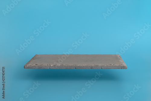 Levitating the rectangular pedestal on a blue background. Stand for your design or text.