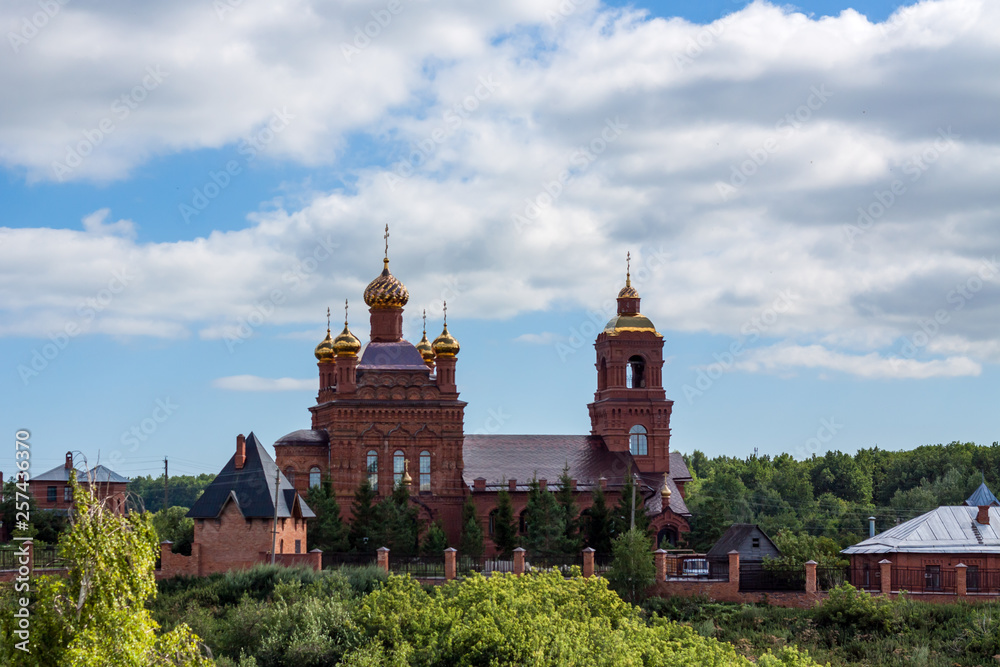 A large Church with Golden domes against the sky.