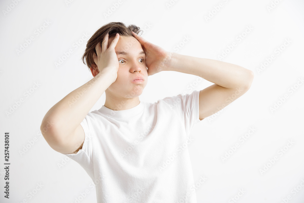 Why is that. Beautiful male half-length portrait isolated on gray studio backgroud. Young emotional surprised, frustrated and bewildered man. Human emotions, facial expression concept. Why is that. Beautiful male half-length portrait isolated on gray studio backgroud. Young emotional surprised, frustrated and bewildered man. Human emotions, facial expression concept.