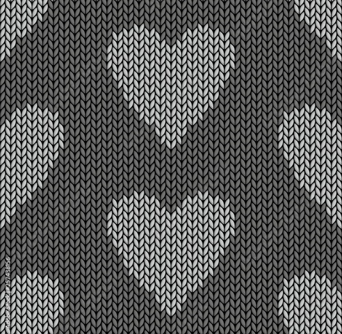 The Seamless gray knitted background with hearts.