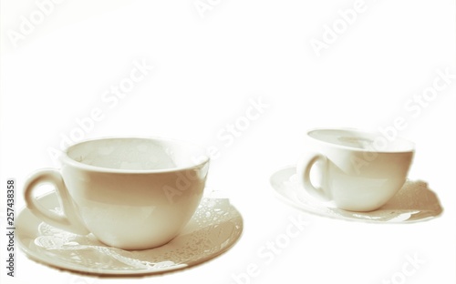 Two white porcelain coffee cups.