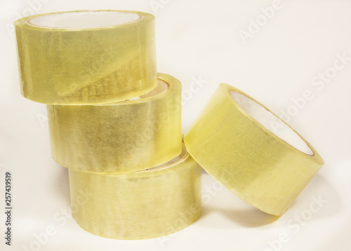 Several rolls of transparent packaging, scotch tape, photographed on white
