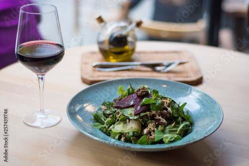 Vegeterian salad on table with red wine