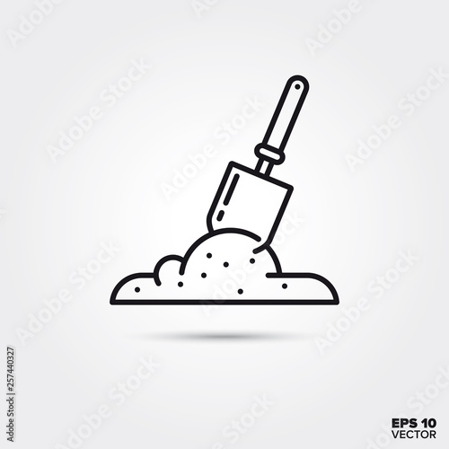 Shovel in soil vector line icon