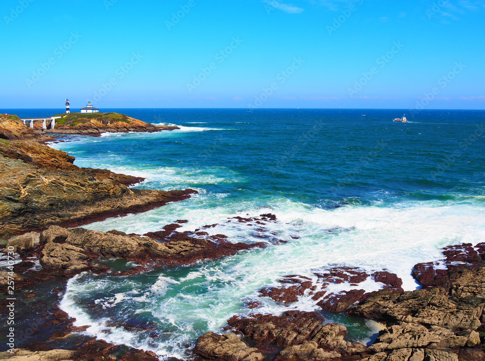 View of the coast and lighthouse of Illa Pancha in Ribadeo, Lugo, Galicia - Spain