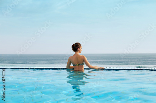 Woman enjoying relaxation in pool and looking © verona_studio