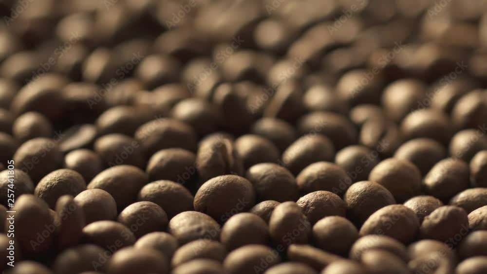 Coffee beans rotation in the slowed-down movement macro. Beautiful view. Coffee beans rotation in the slowed-down movement macro. Beautiful view.