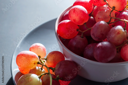 A plate of fresh pink grapes photo