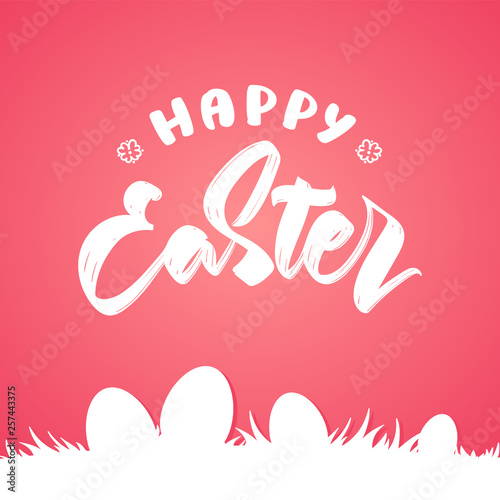 Greeting card with handw drawn lettering of Happy Easter with silhouette of eggs on grass on pink background.
