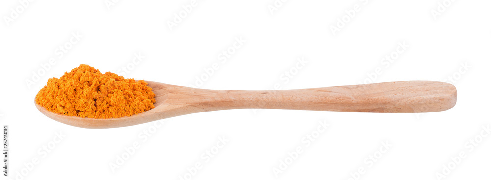 Turmeric powder in a wooden spoon isolated on white background Turmeric powder in a wooden spoon isolated on white background