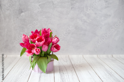 A bouquet of tulips on a gray concrete background with copyspace