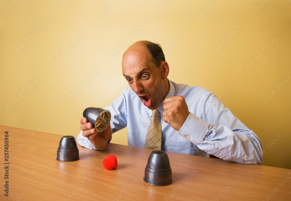 Middle aged caucasian magician practising tricks Middle aged caucasian magician practising tricks